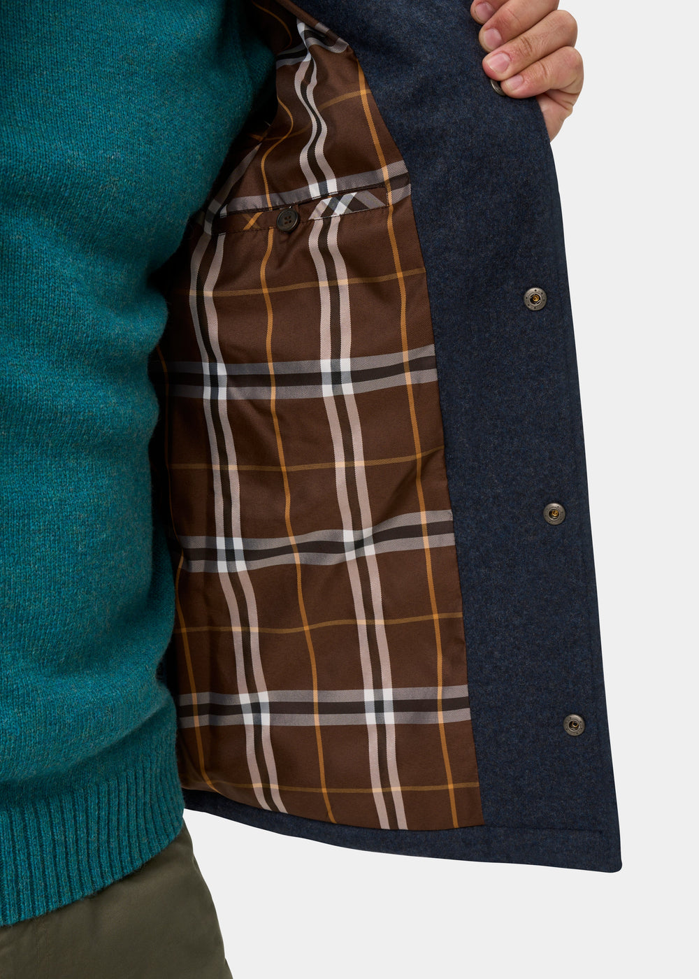 Richmond Men’s Knitted Quilted Shacket in navy worn over a teal sweater, showing the brown plaid lining and button-front.
