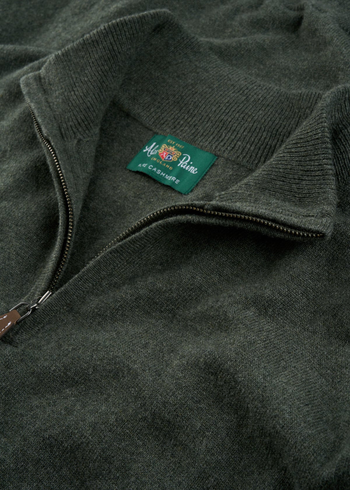 Close-up of a rosemary Hanbury Pure Cashmere Quarter Zip Jumper, regular fit, with label near the collar.