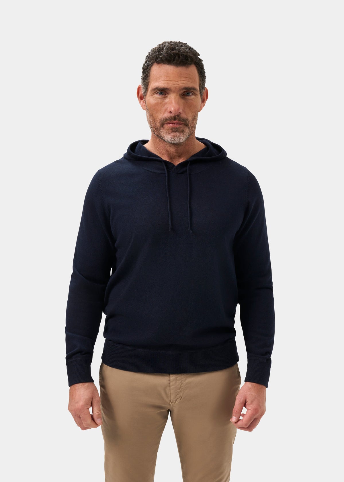 Man in Gaisby Cotton Merino Hoodie in Dark Navy stands facing forward against a plain white background.
