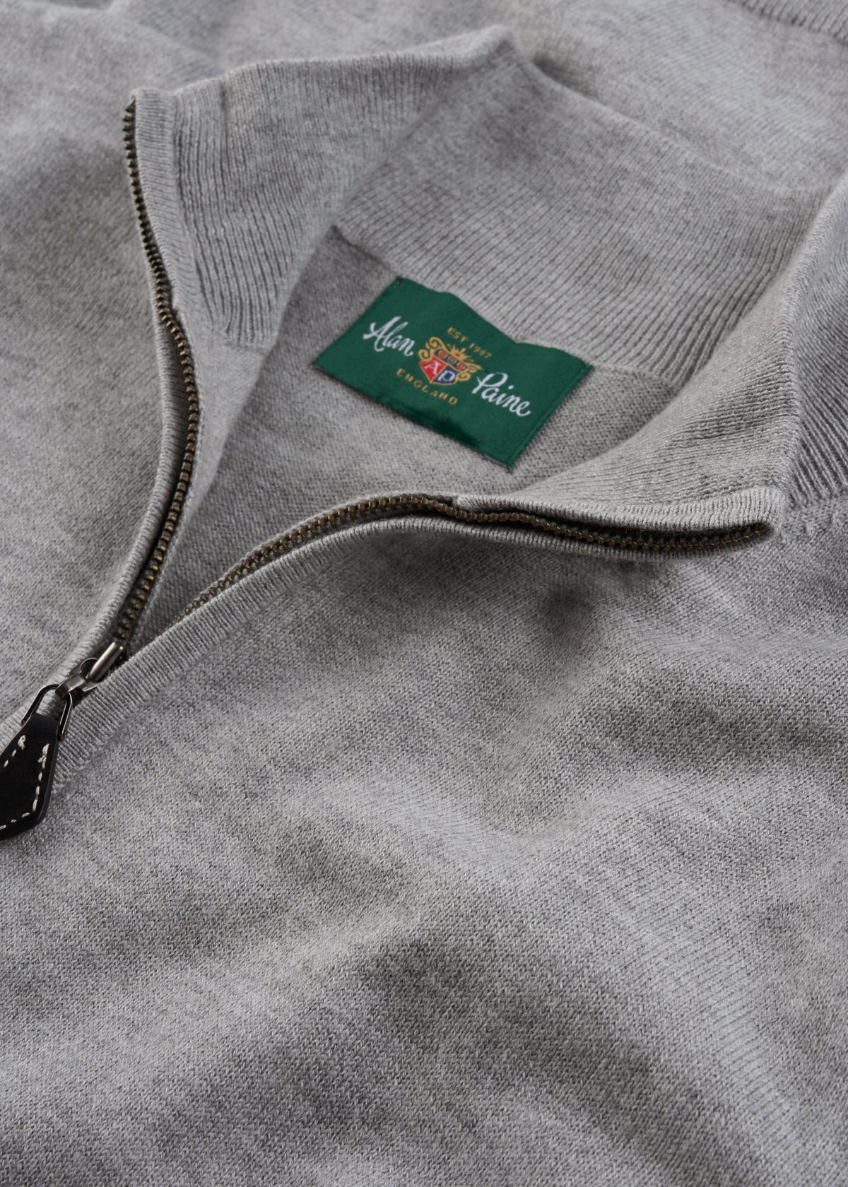Close-up of Ashfield Cotton Merino 1/4 Zip Jumper in Light Grey Mix with green Alan Paine England label.