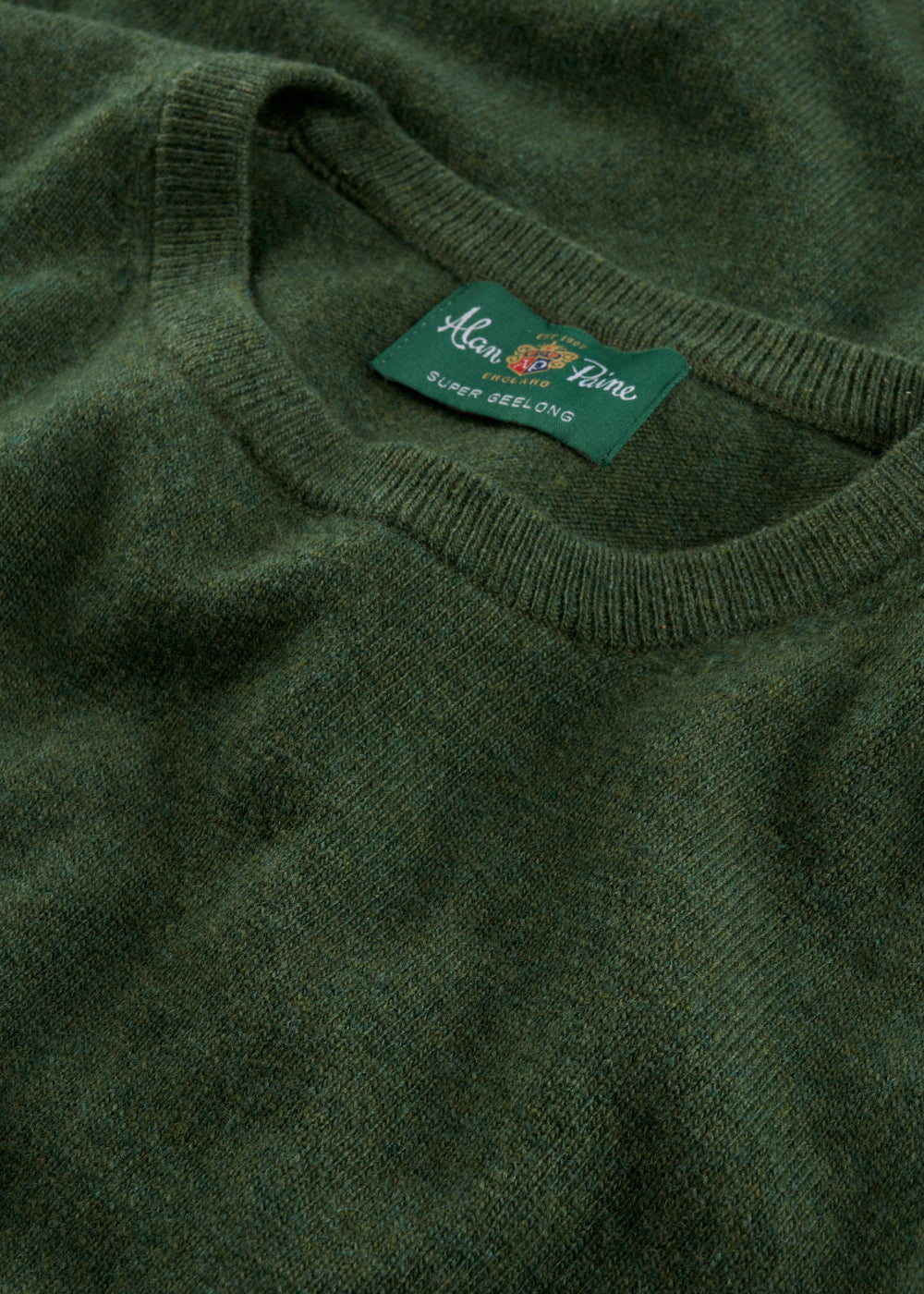 Close-up of a rosemary Brisbane Geelong wool crew neck jumper, regular fit, with Alan Paine label.