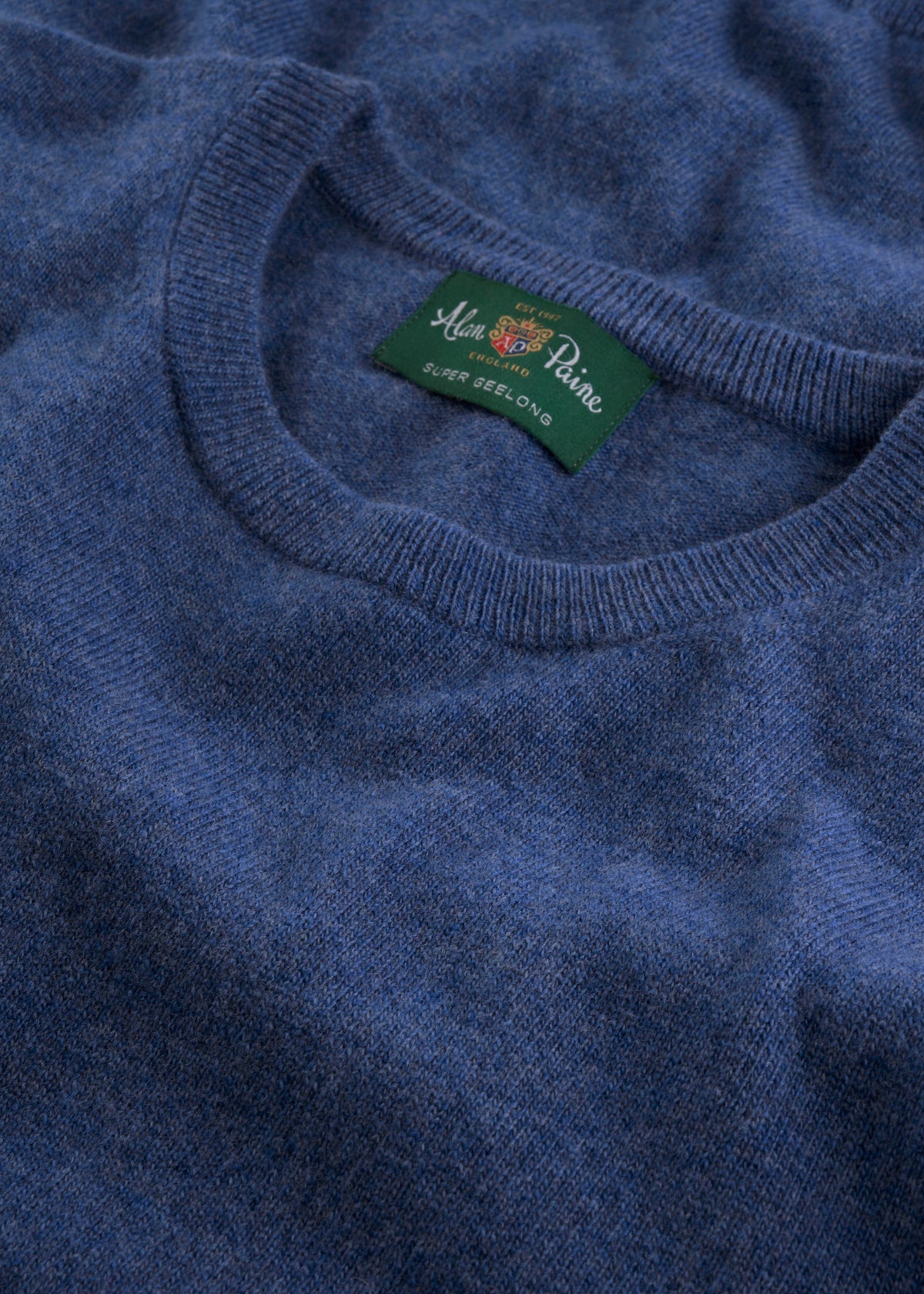Blue Brisbane Geelong wool crew neck jumper, regular fit, with green Alan Paine label inside collar.
