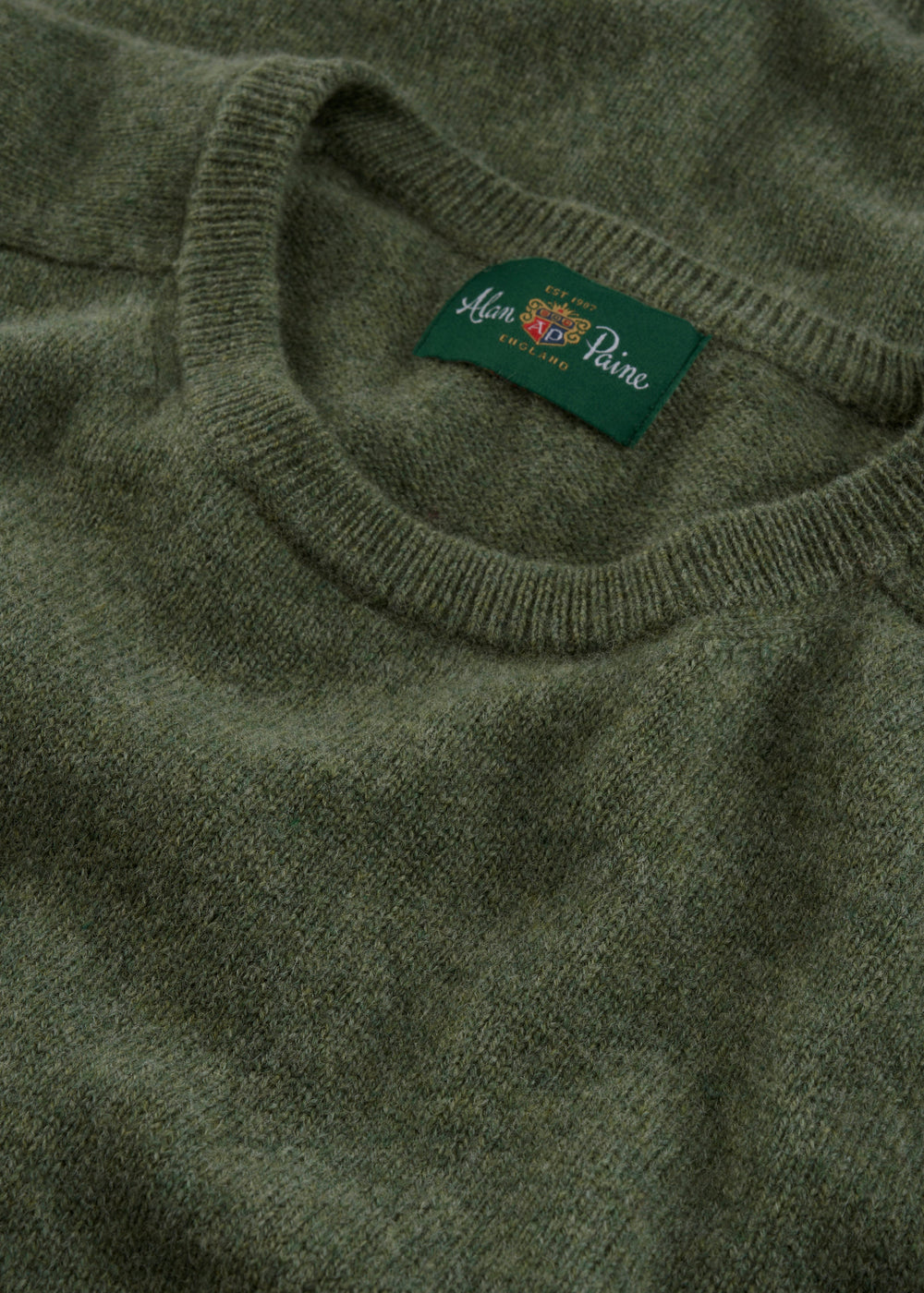 A close-up of the Lenzie Lambswool Crew Neck Jumper in Landscape, featuring an inside collar Alan Paine England label.