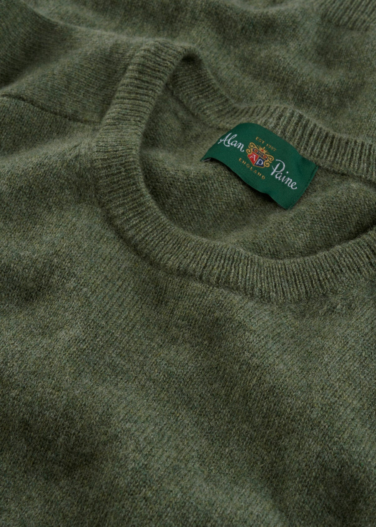 Close-up of Dorset Lambswool Crew Neck Jumper in Landscape, classic fit, with saddle shoulder and visible label.