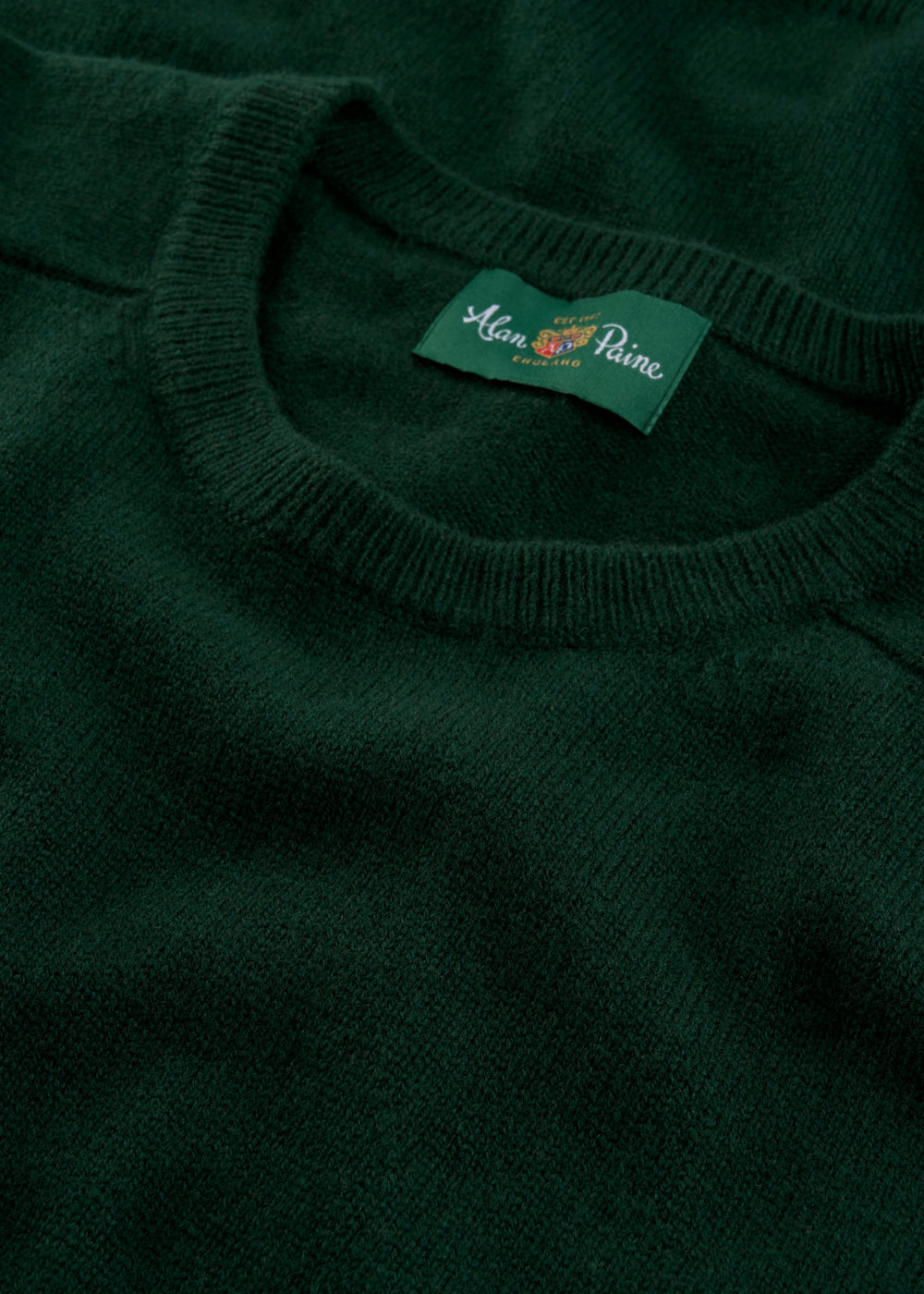 Close-up of Lenzie Lambswool Crew Neck Jumper in Tartan Green - Regular Fit, Alan Paine label on collar.