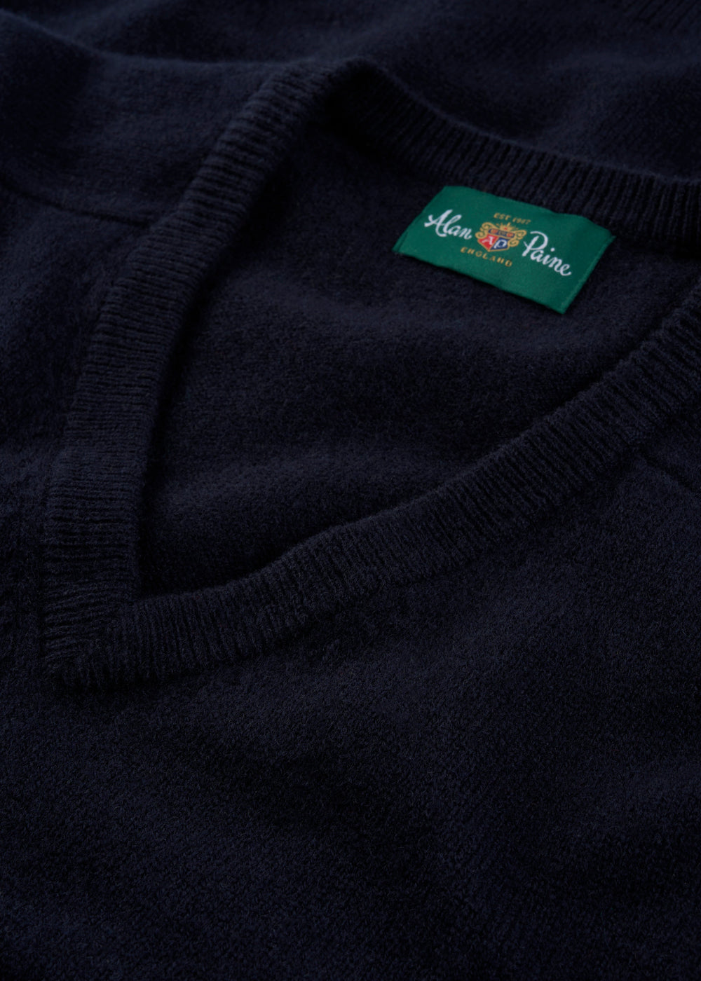Close-up of Kilsyth Lambswool V-Neck Jumper in navy, regular fit, featuring Alan Paine England label.