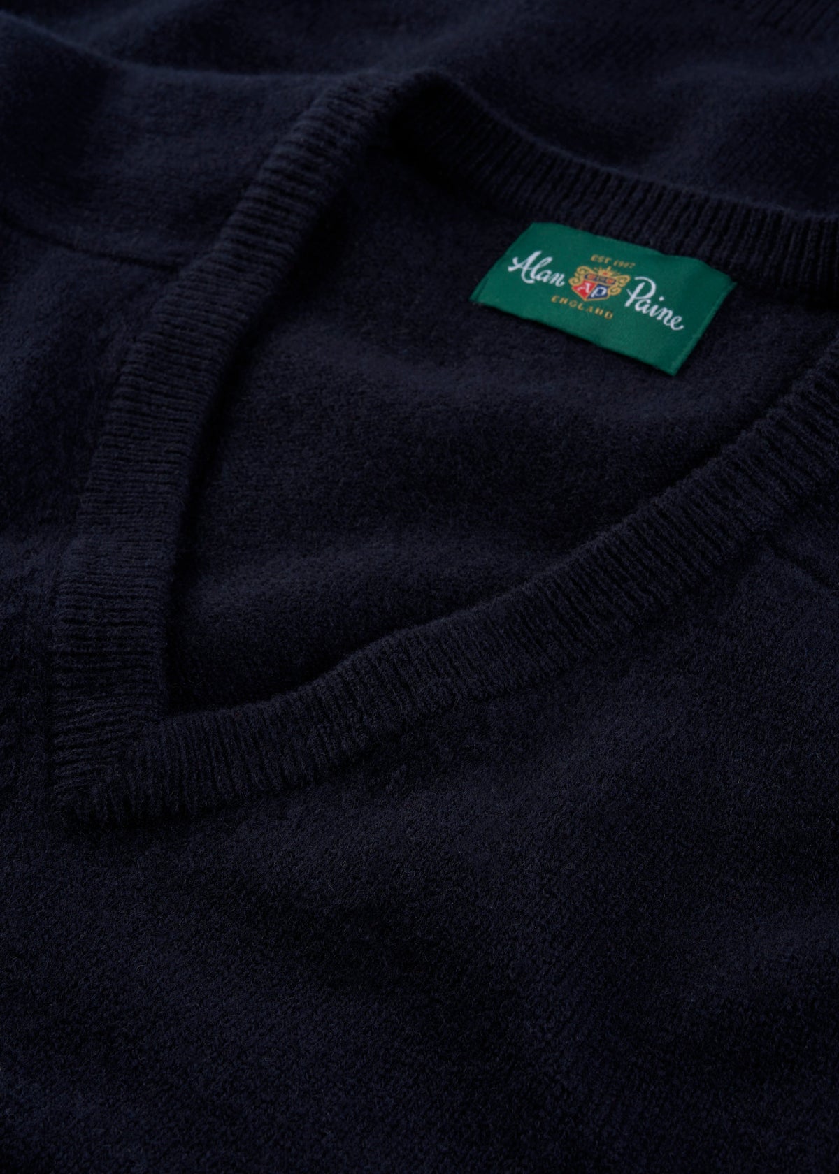 Close-up of Kilsyth Lambswool V-Neck Jumper in navy, regular fit, featuring Alan Paine England label.