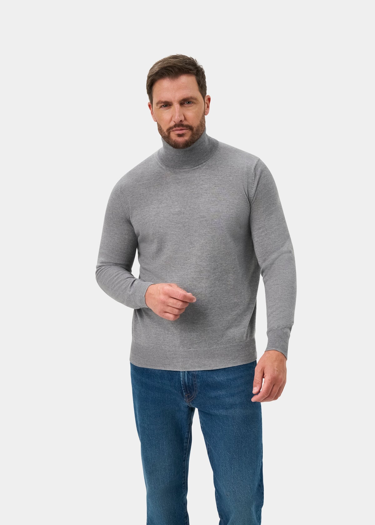 Man in Linton Merino Wool Roll Neck Jumper, Light Grey Mix, Regular Fit, and blue jeans on a white background.