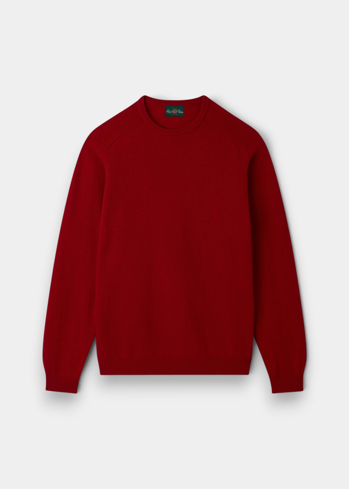 The Dorset Lambswool Crew Neck Jumper in Dubonnet, classic fit, is laid flat on a white background.