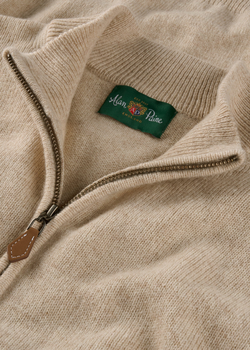 Sutherland Lambswool Quarter Zip Jumper In Linen with a metal zipper pull and an Alan Paine label at the collar.