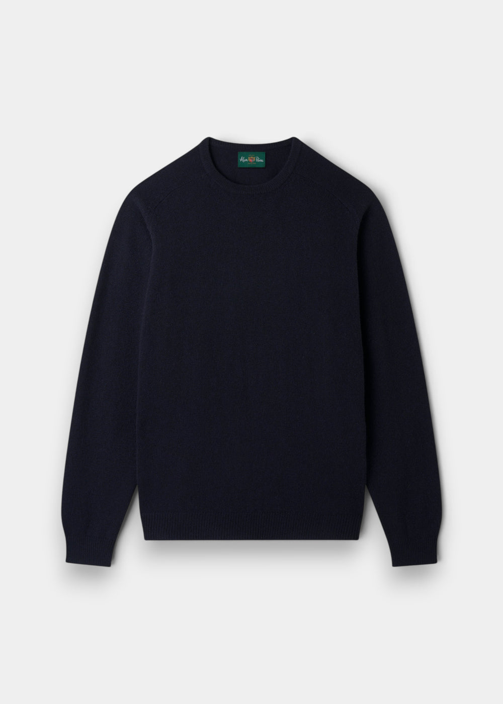 The Dorset Lambswool Crew Neck Jumper in Navy is laid flat, the ideal classic fit layering piece for men.