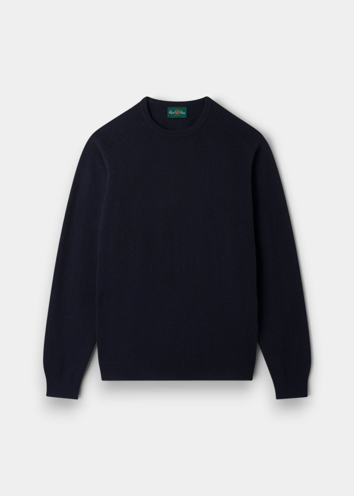 The Dorset Lambswool Crew Neck Jumper in Navy is laid flat, the ideal classic fit layering piece for men.