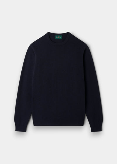 The Dorset Lambswool Crew Neck Jumper in Navy is laid flat, the ideal classic fit layering piece for men.