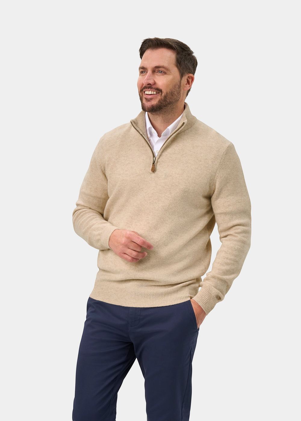 A man wearing a Sutherland Lambswool Quarter Zip Jumper In Linen over a white collared shirt and dark trousers.