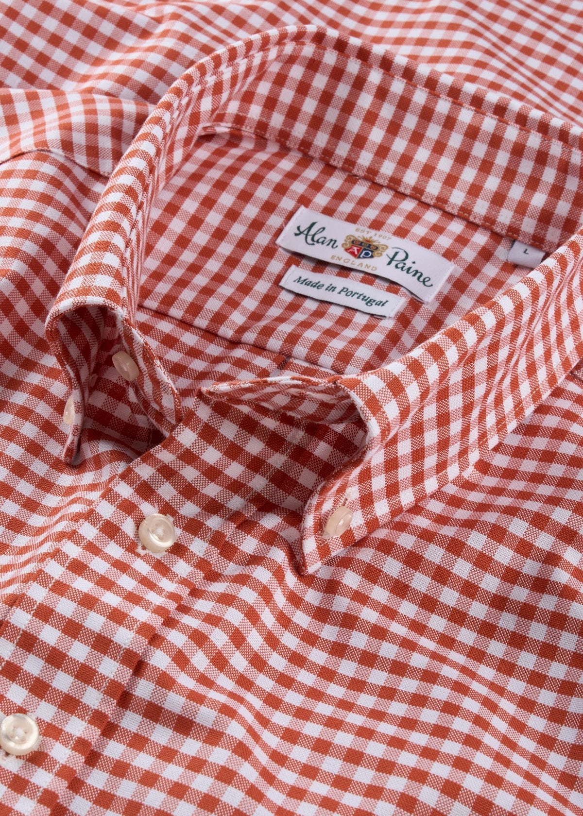 Close-up of red and white checkered classic fit shirt, cotton fabric, button front, made in Portugal.