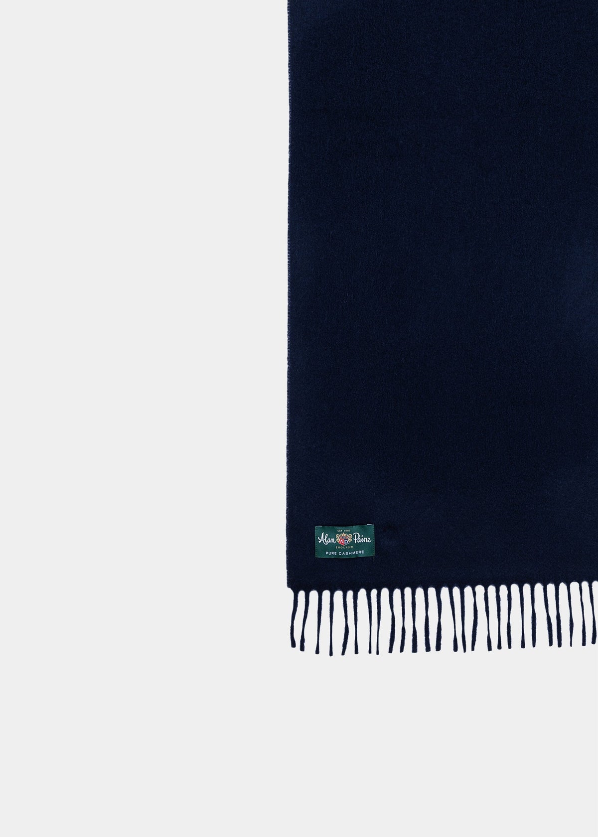Risbury Men’s Cashmere Plain Scarf In Navy with a fringed edge and a small brand label at the bottom corner.
