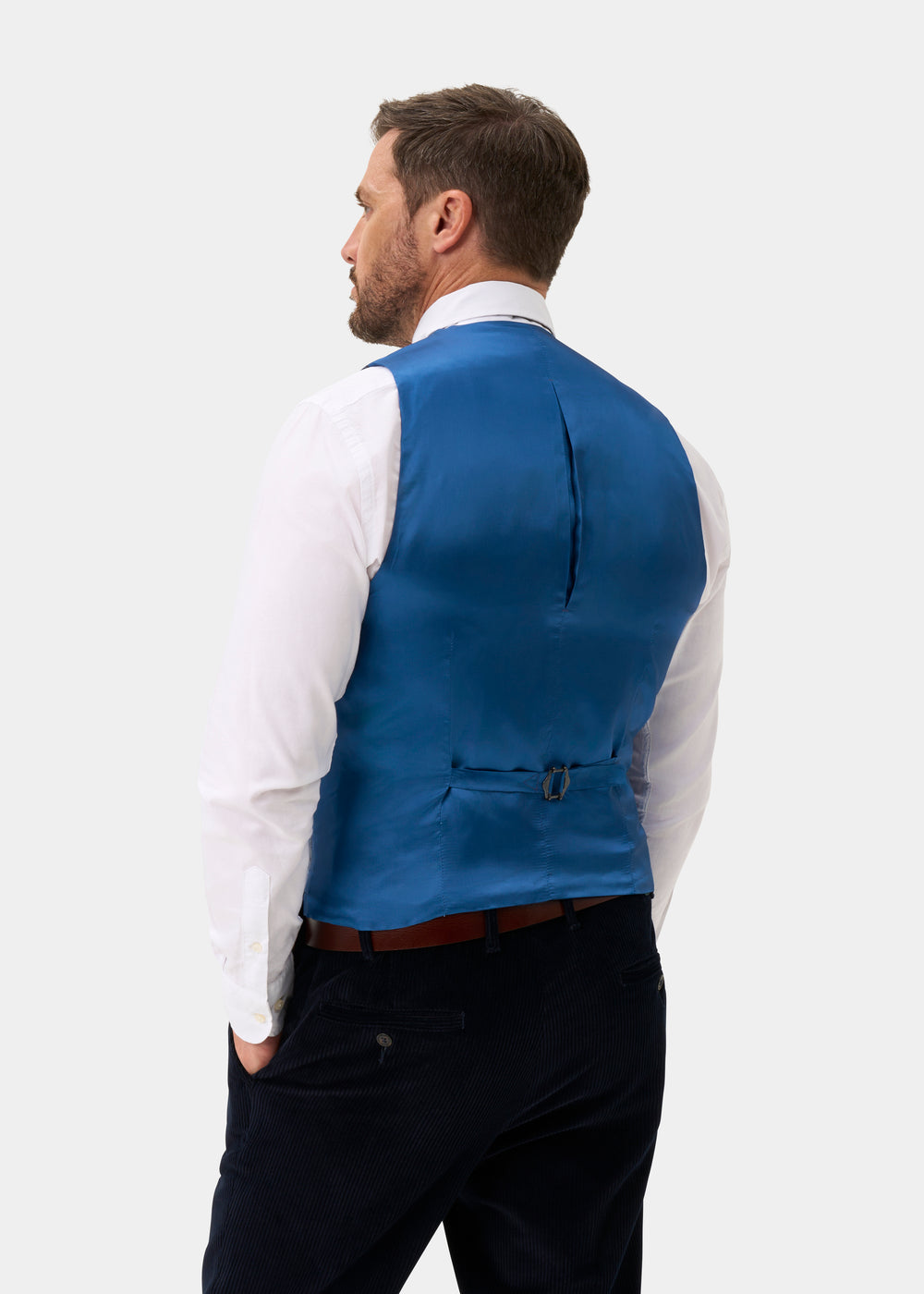 A man from behind in a white dress shirt and Surrey Men’s Tweed Water Repellent Lined Waistcoat with an adjustable strap.